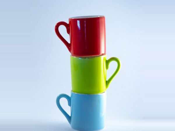 Three stacked mugs in red, green and blue